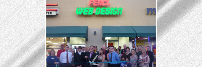Official opening of Fencl Web Design with oversized scissors to cut the tape