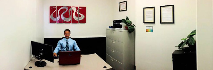 Bret Fencl sitting in his office in front of a computer