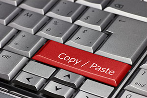 Plagiarizing is a serious offense with a keyboard with white keys but copy and paste are red Website Copyright